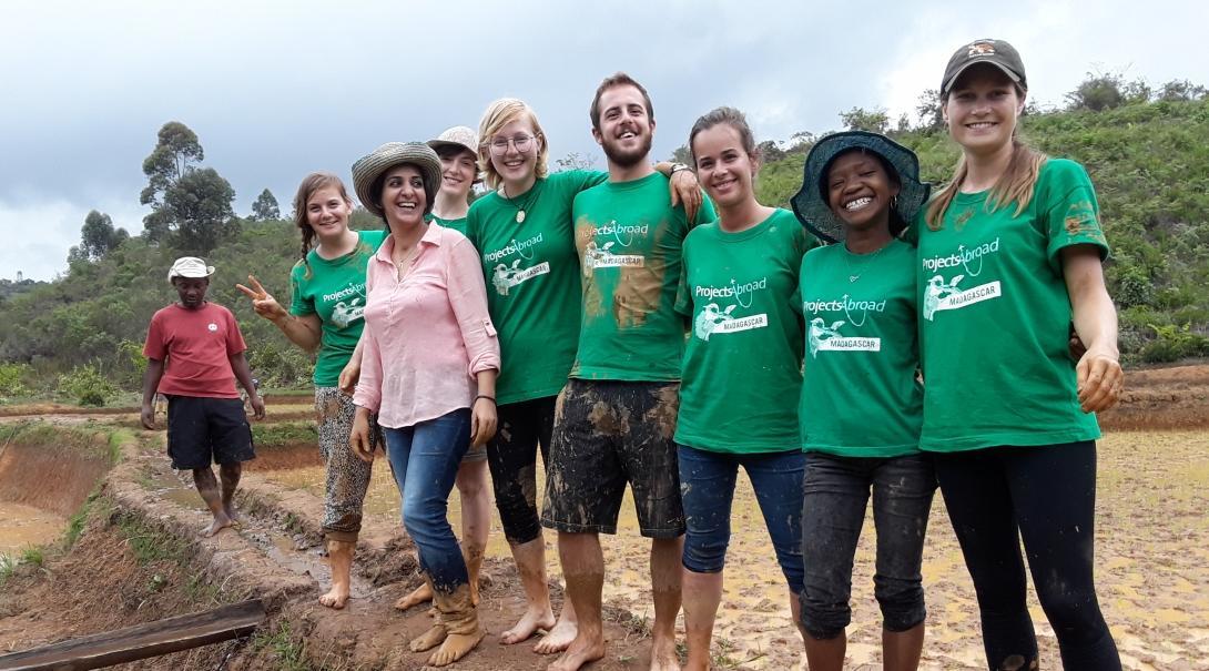 A group of Projects Abroad volunteers in Madagascar. Projects Abroad volunteers celebrate after planting rice together in Madagascar.